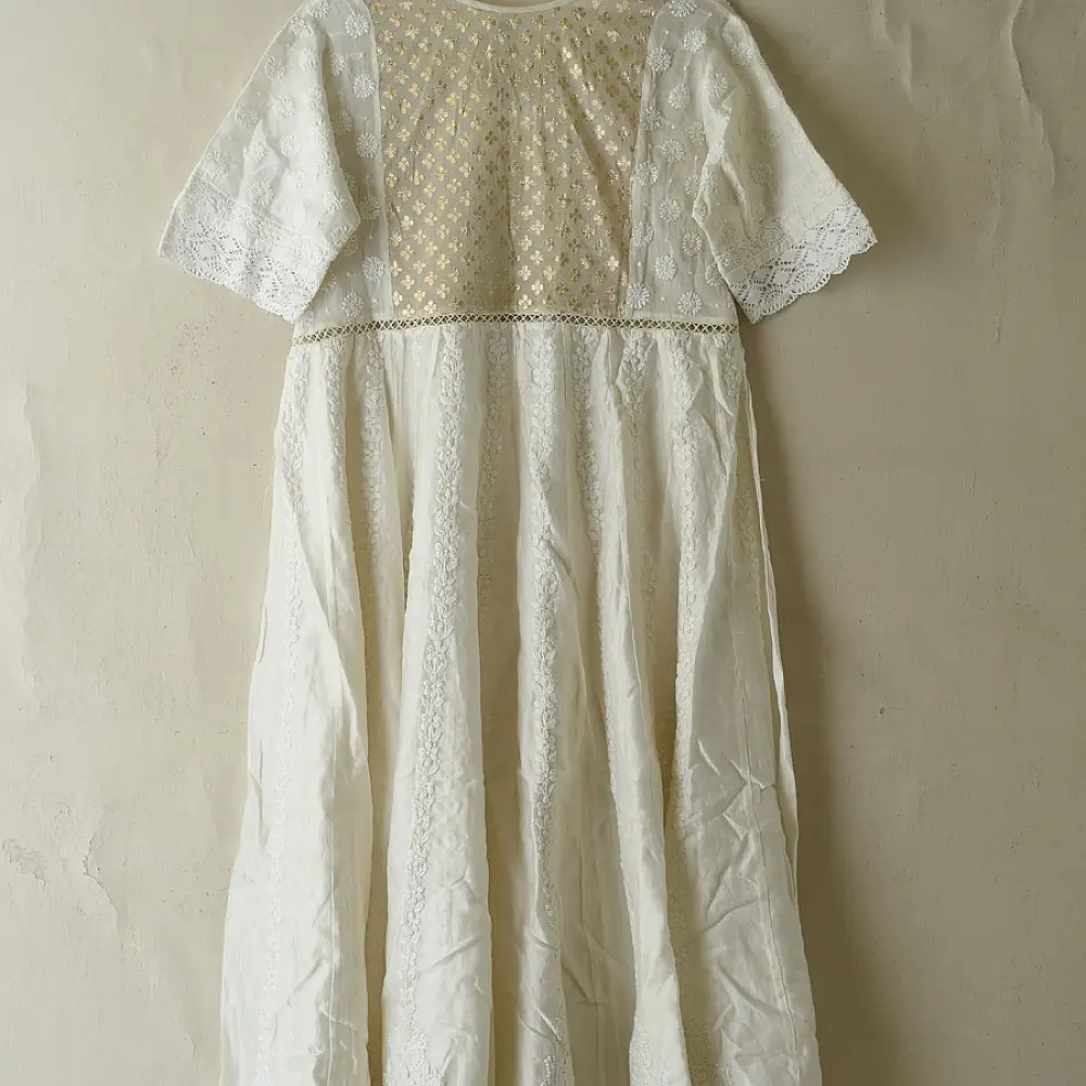 semi stitched pure silk chanderi kurti in off white with intricate hand embroidered resham chikankari and metallic brocade bodice details