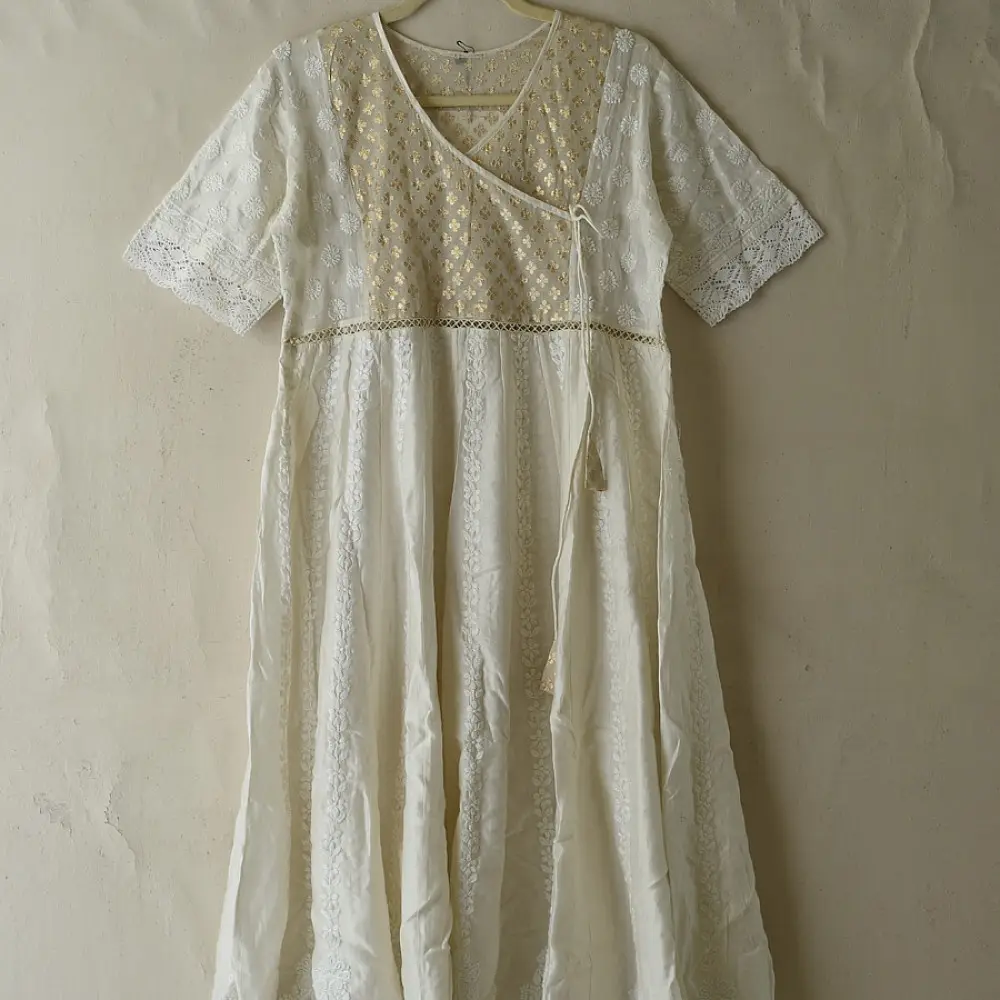 semi stitched pure silk chanderi kurti in off white with intricate hand embroidered resham chikankari and metallic brocade bodice details