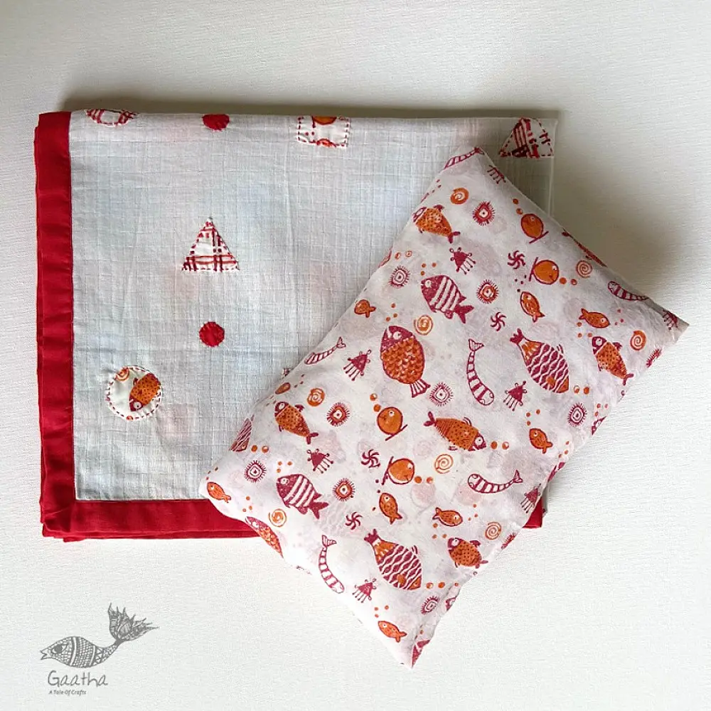 organic cotton kids bedding gift set featuring a cream fish print dohar blanket and a matching koi fish kapok pillow