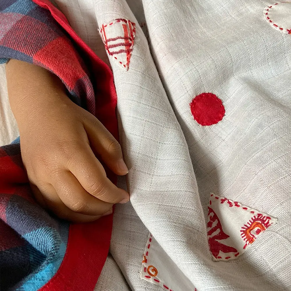 organic cotton kids bedding gift set featuring a cream fish print dohar blanket and a matching koi fish kapok pillow