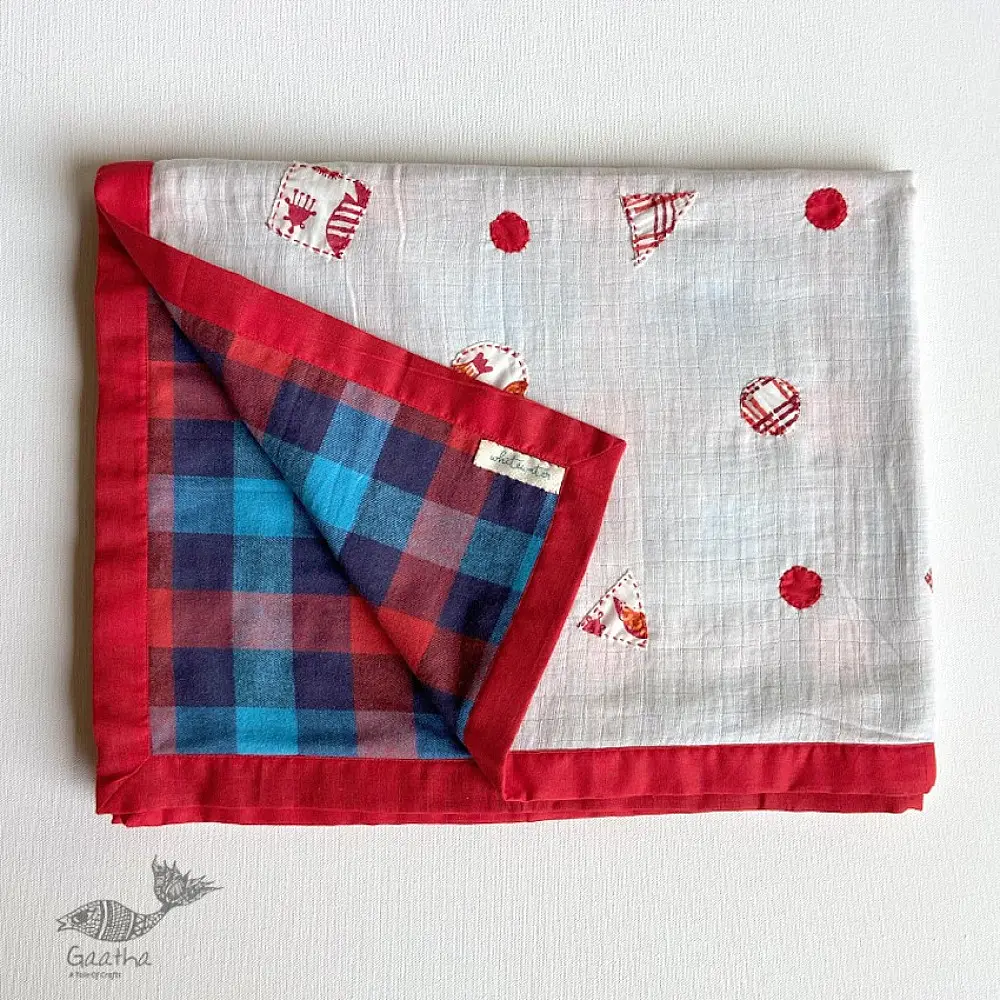 organic cotton kids bedding gift set featuring a cream fish print dohar blanket and a matching koi fish kapok pillow