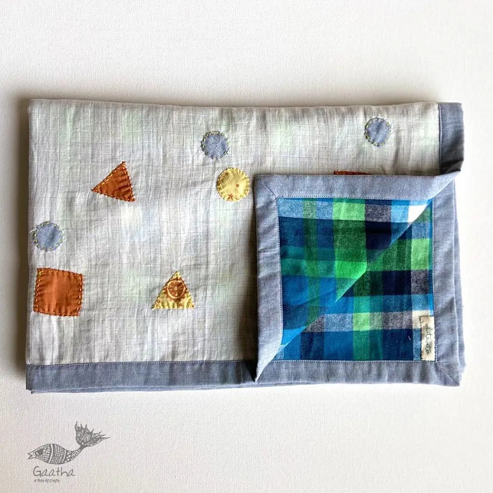 organic cotton kids bedding gift set featuring a cream block printed dhruvtara star dohar blanket sun shaped mustard seed pillow and wooden maracas