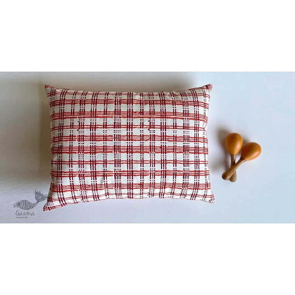organic cotton kids gift set featuring a red and white checked kapok pillow and wooden maracas shakers