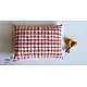 organic cotton kids gift set featuring a red and white checked kapok pillow and wooden maracas shakers