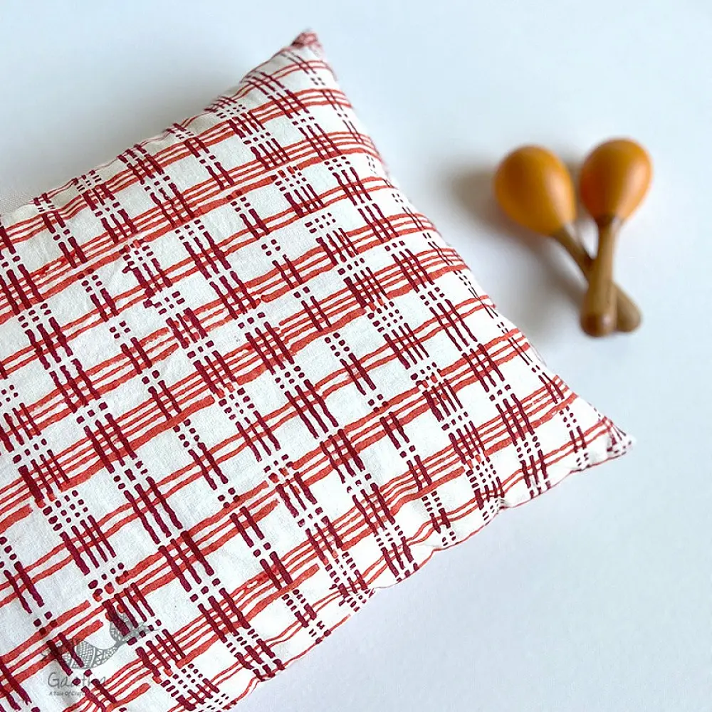 organic cotton kids gift set featuring a red and white checked kapok pillow and wooden maracas shakers