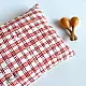 organic cotton kids gift set featuring a red and white checked kapok pillow and wooden maracas shakers