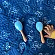 organic cotton newborn luxury bedding gift set in indigo blue zoo print featuring a soft dohar blanket round ruffle pillow matching bolsters and wooden maracas