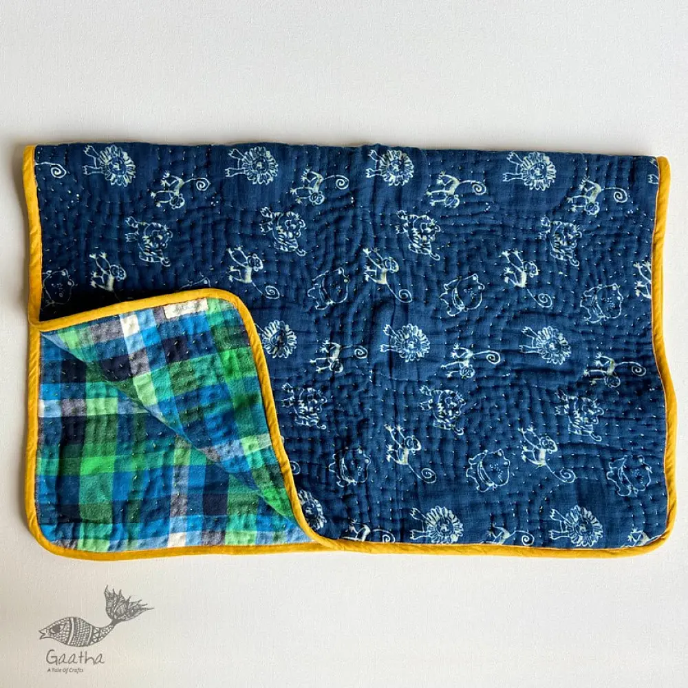 organic cotton newborn luxury bedding gift set in indigo blue zoo print featuring a soft dohar blanket round ruffle pillow matching bolsters and wooden maracas
