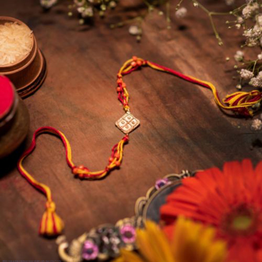 shop handmade dhokra brass rakhi  Red & Yellow Thread